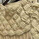 A handknit sweater by Sumac.
